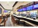 Image showcases bar and dining area with modern finishes, multiple tv's and comfortable seating for patrons at 6065 Magpie Dr, Lakeland, FL 33809