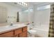 Bright bathroom featuring a shower-tub combo, a neutral vanity, and a well-lit mirror at 6065 Magpie Dr, Lakeland, FL 33809
