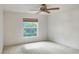 Cozy bedroom featuring a ceiling fan, a window with blinds, and neutral carpet at 6065 Magpie Dr, Lakeland, FL 33809