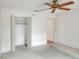 Bedroom featuring an open closet, carpet, ceiling fan and entry to another room at 6065 Magpie Dr, Lakeland, FL 33809