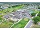 Aerial view of the community clubhouse, pool, tennis courts, and golf course at 6065 Magpie Dr, Lakeland, FL 33809