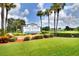 Sandpiper Golf and Country Club sign with lush green grass and tall palm trees at 6065 Magpie Dr, Lakeland, FL 33809