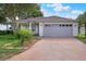 Charming single-story home featuring a two-car garage and well-maintained front yard landscaping at 6065 Magpie Dr, Lakeland, FL 33809