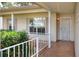 Inviting front porch with secure screen door and white railing at 6065 Magpie Dr, Lakeland, FL 33809