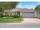 Charming home featuring a well-manicured front yard with lush landscaping and a two-car garage at 6065 Magpie Dr, Lakeland, FL 33809