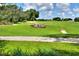 Scenic view of The Links golf course featuring green fairways, a sand trap, and manicured landscaping at 6065 Magpie Dr, Lakeland, FL 33809