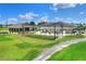 A view of the driving range with putting green and seating area, nestled on a golf course at 6065 Magpie Dr, Lakeland, FL 33809
