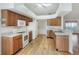 Spacious kitchen with wood cabinets, white appliances, and laminate flooring at 6065 Magpie Dr, Lakeland, FL 33809