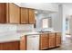Kitchen featuring wood cabinetry, laminate countertops, and stainless steel sink at 6065 Magpie Dr, Lakeland, FL 33809