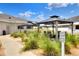 Exterior shot of the clubhouse with charming gazebos, seating area, and meticulous landscaping at 6065 Magpie Dr, Lakeland, FL 33809