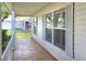 Comfortable front porch with decorative concrete flooring and white pillars with shutters at 6065 Magpie Dr, Lakeland, FL 33809