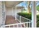 Inviting covered front porch featuring a white railing with decorative concrete flooring and columns at 6065 Magpie Dr, Lakeland, FL 33809