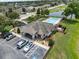 Aerial view of the community pool, playground, clubhouse, parking area, and pond at 6250 Silver Leaf Ln, Lakeland, FL 33813
