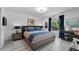 Well-lit bedroom with a patterned bedspread, blue accents, and modern decor at 6250 Silver Leaf Ln, Lakeland, FL 33813