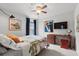 Well-lit bedroom featuring a work space and comfortable bed at 6250 Silver Leaf Ln, Lakeland, FL 33813