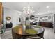 Open concept dining area with a chandelier, a round table with chairs, leading to a well-equipped kitchen at 6250 Silver Leaf Ln, Lakeland, FL 33813