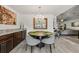 Bright dining area with modern light fixture, dark wood table, comfortable seating, and elegant decor at 6250 Silver Leaf Ln, Lakeland, FL 33813