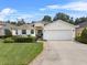 Charming single Gathering home with a well-manicured lawn, tidy landscaping, and a two-car garage at 6250 Silver Leaf Ln, Lakeland, FL 33813