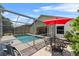 Enjoy poolside relaxation on the patio with picturesque backyard views at 6250 Silver Leaf Ln, Lakeland, FL 33813