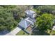 Aerial view showcasing the property's expansive lot, swimming pool, and mature trees at 645 E Church St, Bartow, FL 33830