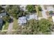 Aerial view of a single Gathering home featuring a backyard pool and beautiful landscaping, nestled amongst mature trees at 645 E Church St, Bartow, FL 33830