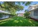 Backyard featuring a screened pool area and lush green landscaping, perfect for outdoor entertaining at 645 E Church St, Bartow, FL 33830