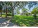 The backyard features a large lawn and shady trees at 645 E Church St, Bartow, FL 33830