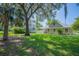 The backyard features a large lawn and mature trees at 645 E Church St, Bartow, FL 33830