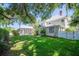 Lush backyard featuring a screened-in pool area, mature trees, and a well-manicured lawn at 645 E Church St, Bartow, FL 33830