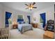 Cozy bedroom with bright windows, a ceiling fan, and a crib at 645 E Church St, Bartow, FL 33830