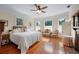 Charming bedroom featuring a ceiling fan, hardwood floors and decorative seating area at 645 E Church St, Bartow, FL 33830