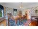Charming dining room features floral wallpaper, an elegant table, and exterior views at 645 E Church St, Bartow, FL 33830
