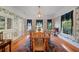 Bright dining room offers multiple windows, hardwood floors, and stylish decor at 645 E Church St, Bartow, FL 33830