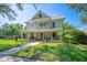 Charming two-story home with a welcoming front porch and beautiful landscaping at 645 E Church St, Bartow, FL 33830