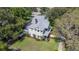 Aerial view of a charming two-story home boasting a well-manicured lawn and mature trees at 645 E Church St, Bartow, FL 33830