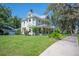 Charming two-story home with lush green lawns and mature landscaping at 645 E Church St, Bartow, FL 33830