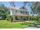 Charming two-story home with a welcoming front porch and mature trees at 645 E Church St, Bartow, FL 33830