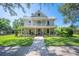 Charming two-story home with a welcoming front porch and lush landscaping at 645 E Church St, Bartow, FL 33830