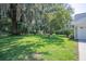 Expansive front yard with lush green lawn, mature trees, and well-maintained landscaping at 645 E Church St, Bartow, FL 33830