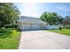 Spacious three-car garage with a large driveway and well-maintained landscaping at 645 E Church St, Bartow, FL 33830