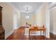 Hallway with hardwood floors and a quaint window leads to other areas of the home at 645 E Church St, Bartow, FL 33830