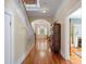 Long hallway with hardwood floors, staircase, and views into the living spaces at 645 E Church St, Bartow, FL 33830