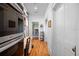 Bright hallway with hardwood floors and built-in storage offers access to other rooms in the house at 645 E Church St, Bartow, FL 33830