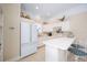Kitchenette with white cabinets, stainless steel fridge, and breakfast bar at 645 E Church St, Bartow, FL 33830