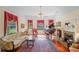 Elegant living room with large windows, period details, and beautiful hardwood floors at 645 E Church St, Bartow, FL 33830