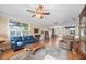 Spacious living room with hardwood floors, ceiling fan, and view into adjacent dining and kitchen at 645 E Church St, Bartow, FL 33830