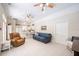 Spacious living room with tiled flooring, ceiling fans, and adjacent kitchen at 645 E Church St, Bartow, FL 33830