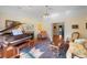 Bright living room featuring a grand piano, decorative fireplace, and traditional furnishings at 645 E Church St, Bartow, FL 33830
