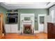 Cozy living area featuring a fireplace, storage cabinets, and beautiful hardwood floors at 645 E Church St, Bartow, FL 33830