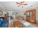 Open living area with hardwood floors, ceiling fan, and seamless transition to dining and kitchen at 645 E Church St, Bartow, FL 33830